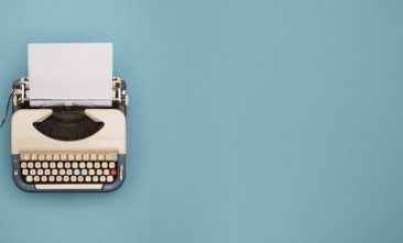 Typewriter on light blue background