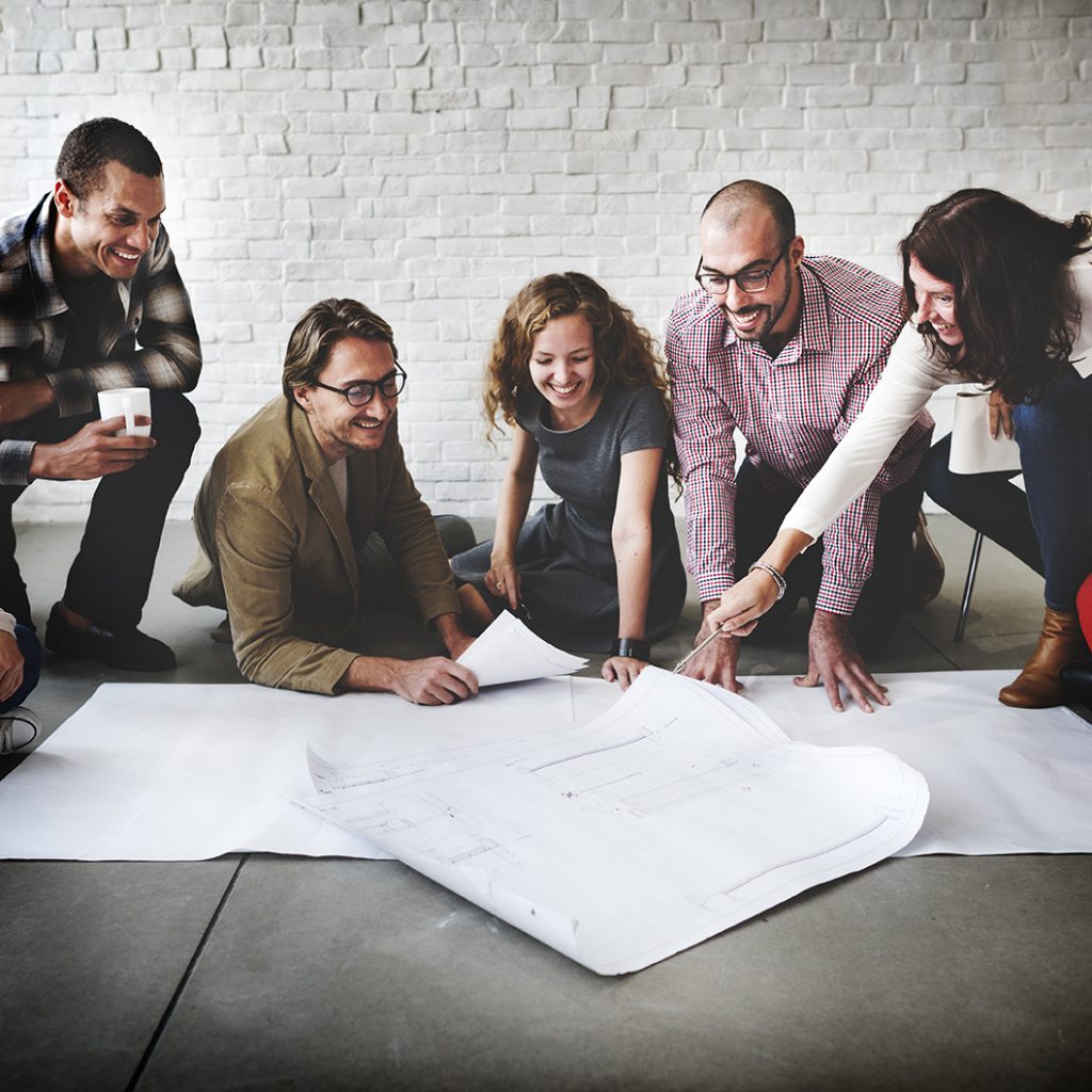 Business team looking at large white papers