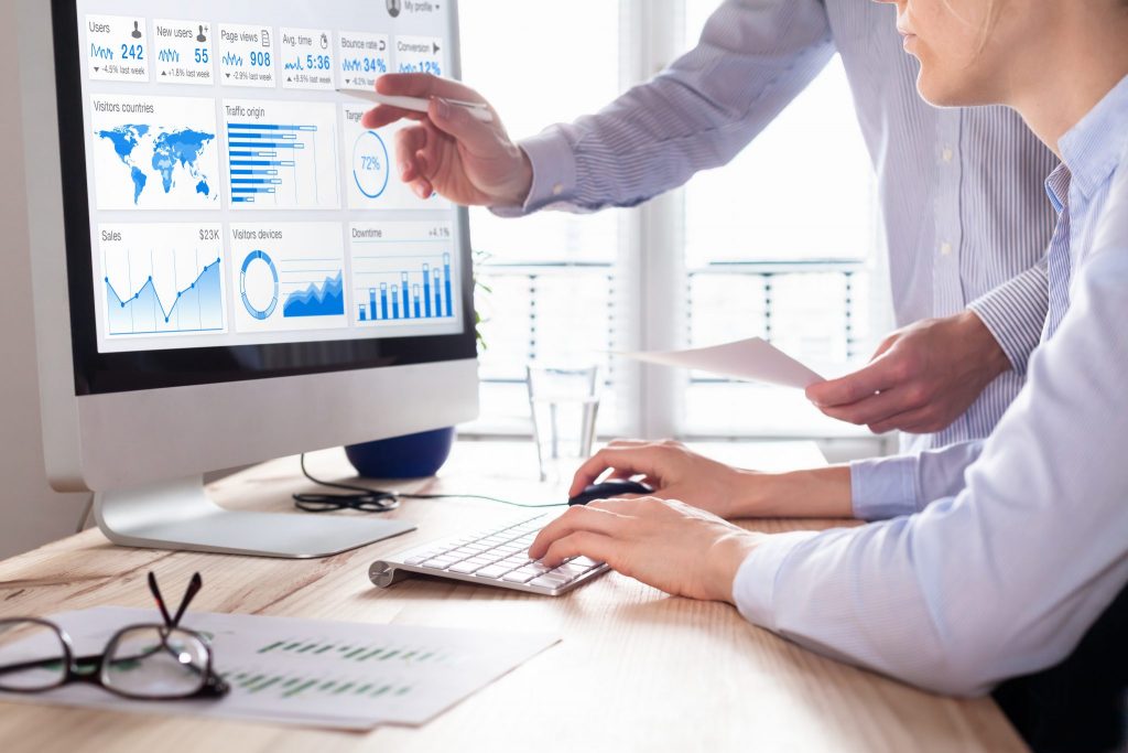 Two coworkers examining data to make decisions about conversion strategies
